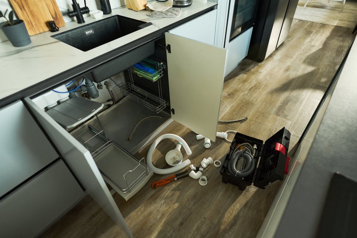 Bathroom under renovation with plumbing tools